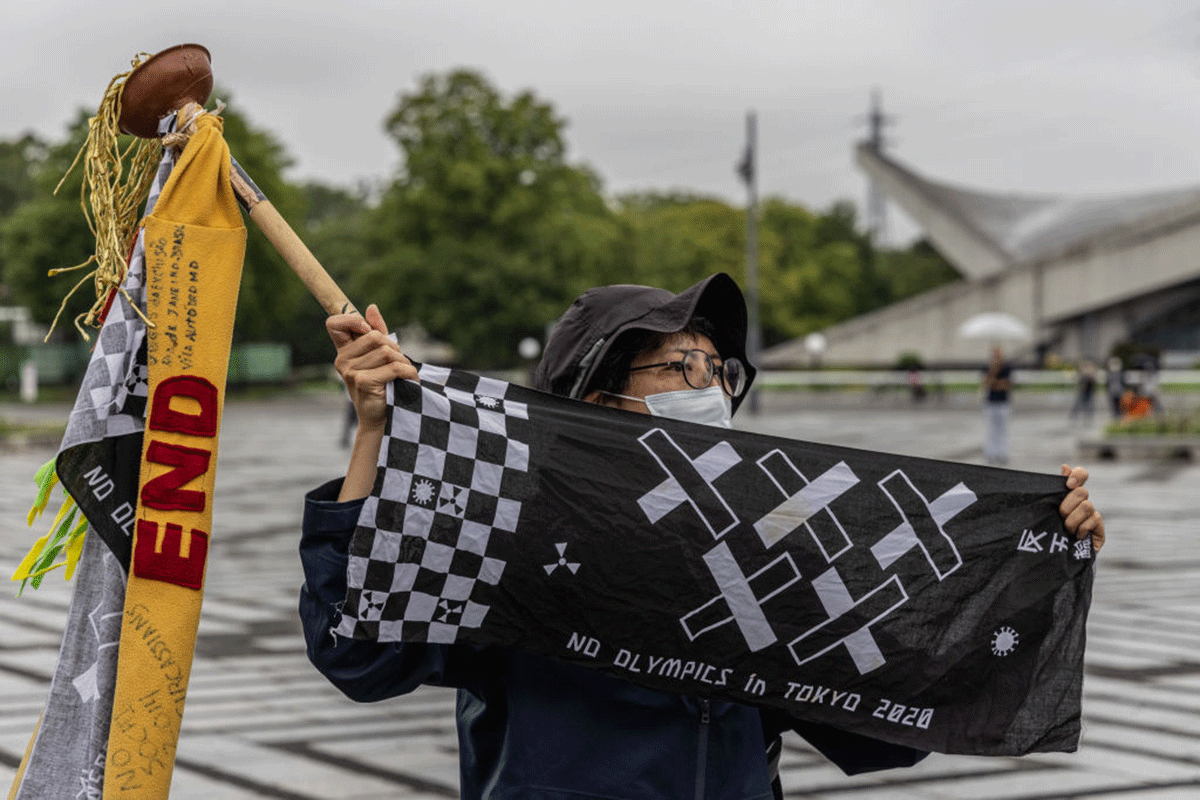 Anti-Olympics protesters demonstrate during an unveiling ceremony for the Tokyo leg of the Olympic torch relay in Komazawa Olympic Stadium on Friday