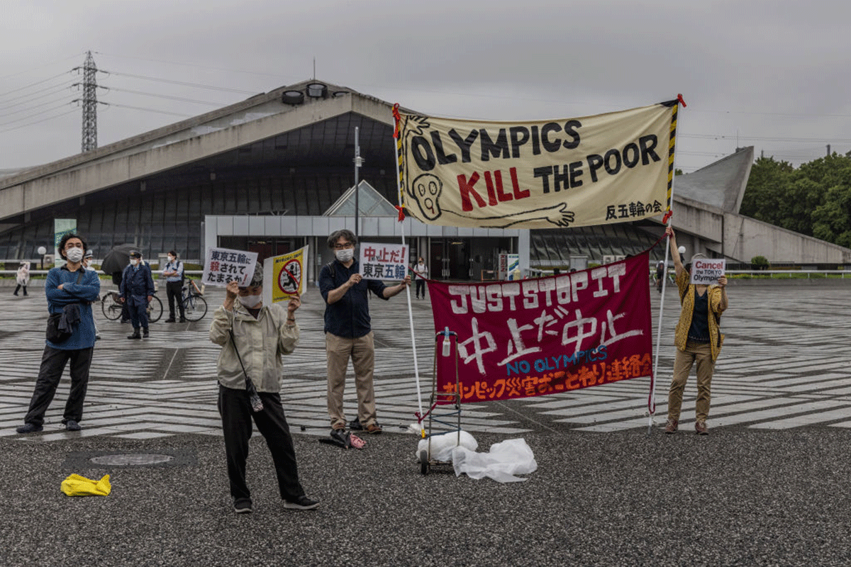 Anti-Olympics protesters demonstrate during an unveiling ceremony for the Tokyo leg of the Olympic torch relay in Komazawa Olympic Stadium