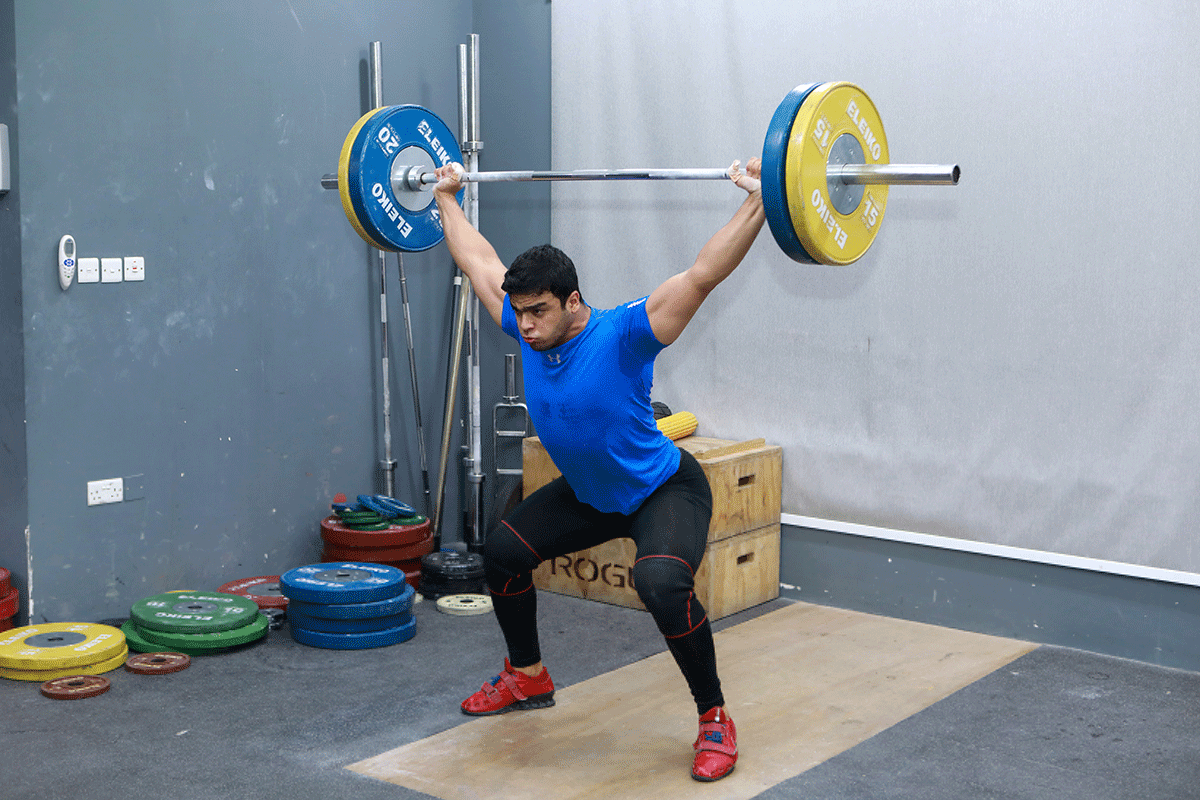 Gaza weight-lifter Mohammad Hamada practices at a gym in Doha, Qatar, on Sunday, July 18. Asad Al-Majdalawi, deputy chairman of the Palestinian Olympic Committee, said Hamada's participation was an achievement regardless of whether he won a medal.