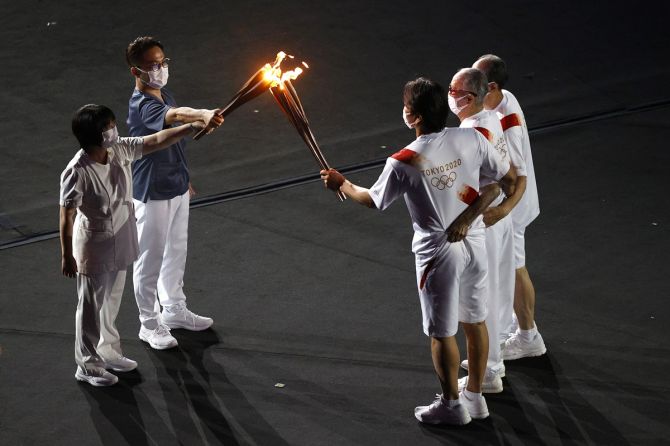 The Olympic Flame is carried into the stadium during the opening ceremony.