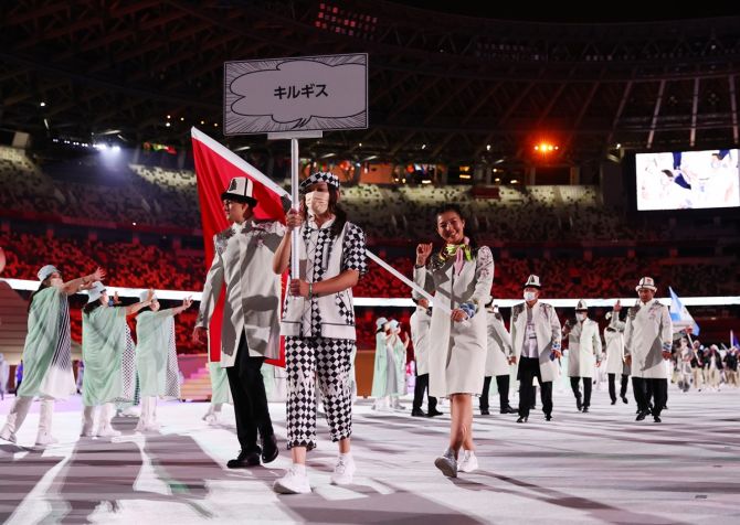 Flagbearers Kanykei Kubanychbekova and Denis Petrashov lead the Kyrgyzstan contingent during the athletes' parade at the Tokyo Olympics opening ceremony on Friday.