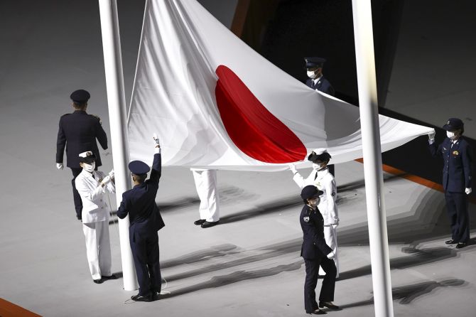 The Japanese flag is raised to the strains of the country's National anthem
