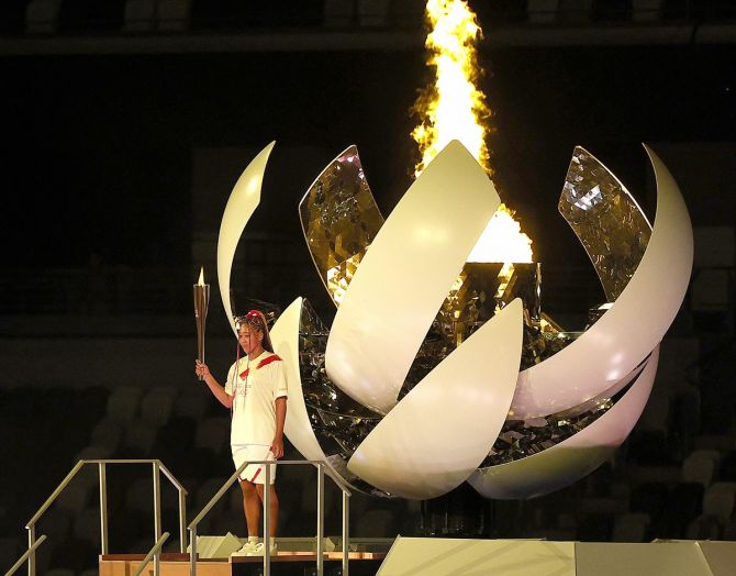 Naomi Osaka of Team Japan lights the Olympic cauldron with the Olympic torch during the Opening Ceremony of the Tokyo 2020 Olympic Games at Olympic Stadium on July 23, 2021 in Tokyo