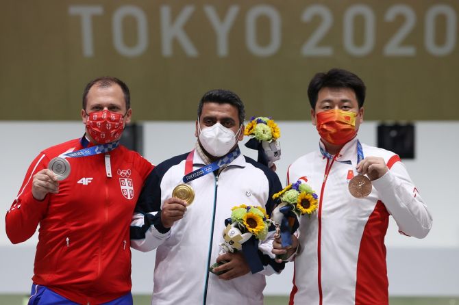 (left to right)) Silver medalist Damir Mikec of Serbia, gold medalist Javad Foroughi of Iran and bronze medalist Wei Pang of China pose with their medals following the 10m men's Air Pistol  event. Kevin C. 