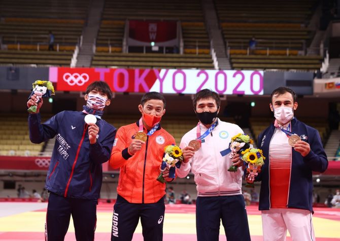Gold medallist Naohisa Takato of Japan poses with silver medallist Yang Yung Wei of Taiwan, bronze medallists Yeldos Smetov of Kazakhstan and Luka Mkheidze of France after the men's 60 kg judo medal ceremony at the Tokyo Olympics, on Saturday