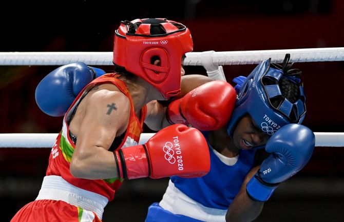 India's Chungneijang Mary Kom  trades punches with the Dominican Republic's Miguelina Hernandez Garcia during the women's Flyweight 48-51kg boxing bout at the Tokyo Olympics, at Kokugikan Arena, on Sunday