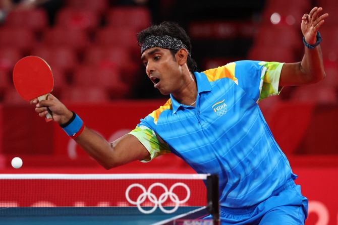 India's Sharath Kamal Achanta in action against China's Ma Long during the Olympics men's singles Round 3 match, at Tokyo Metropolitan Gymnasium , on Tuesday
