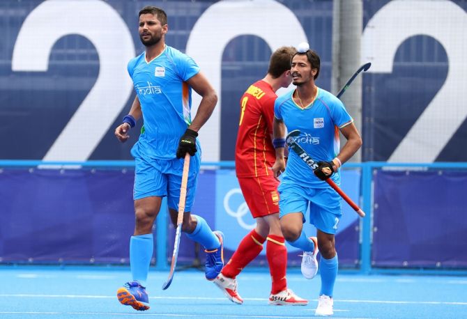 India's Rupinder Pal Singh celebrates with teammate Dilpreet Singh after scoring from a penalty-corner in the men's Olympics hockey match against Spain, at the Oi Hockey stadium, in Tokyo, on Tuesday