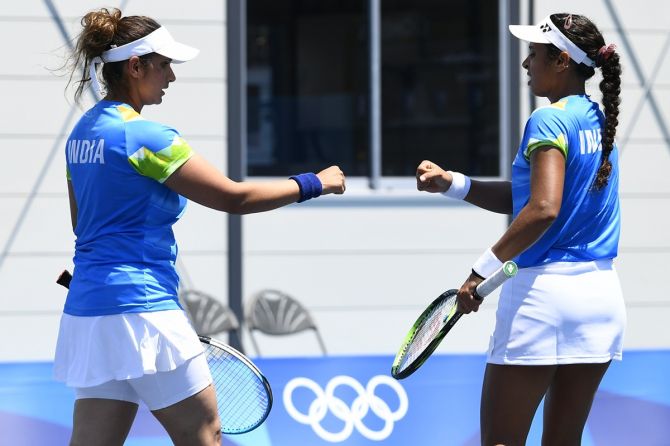 India's Sania Mirza and Ankita Raina react during their first round women's doubles match against Ukraine's Lyudmyla Kichenok and Nadiia Kichenok at the Tokyo Olympics.