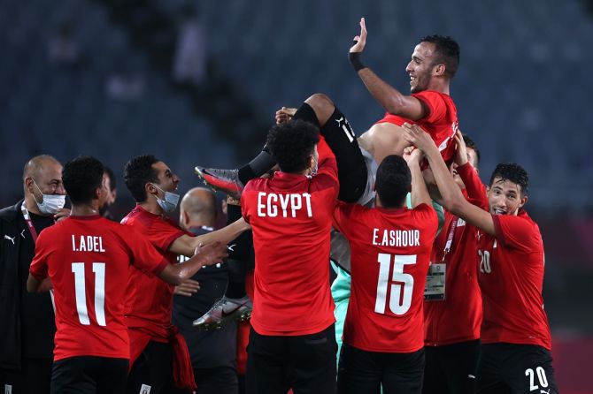Egypt's Nasser Mansi, No. 21, is thrown in the air by teammates following victory over Australia.