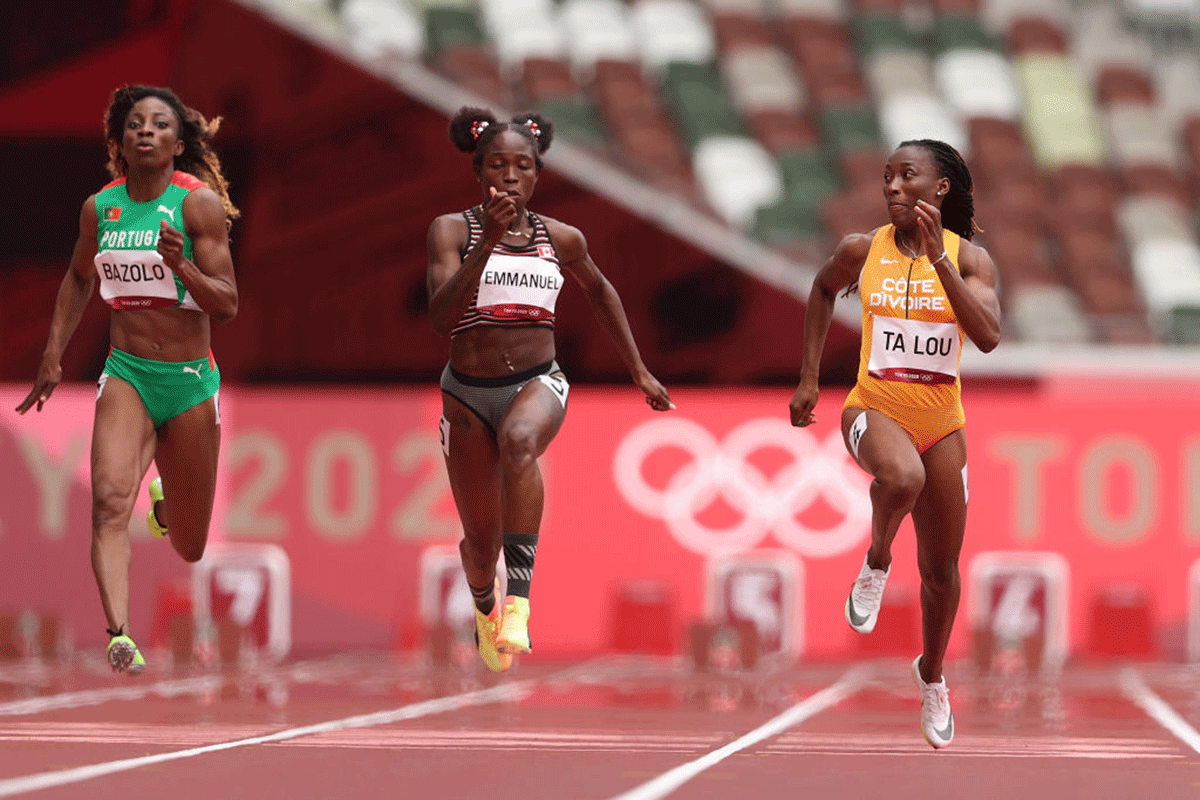 Ivory Coast's Marie-Josee Ta Lou (right) competes during round one of the Women's 100m heats on day seven of the Tokyo 2020 Olympic Games at Olympic Stadium in Tokyo on Friday