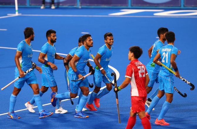 Harmanpreet Singh celebrates with teammates after putting India ahead in the men's Olympics hockey match against Japan on Friday. 