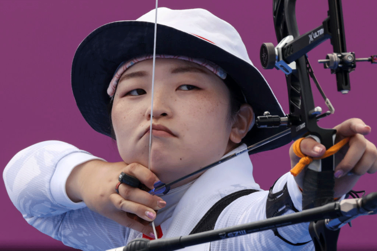 Japan's Miki Nakamura competes in the archery Women's Individual 1/8 Eliminations at the Tokyo 2020 Olympic Games at Yumenoshima Park Archery Field. 