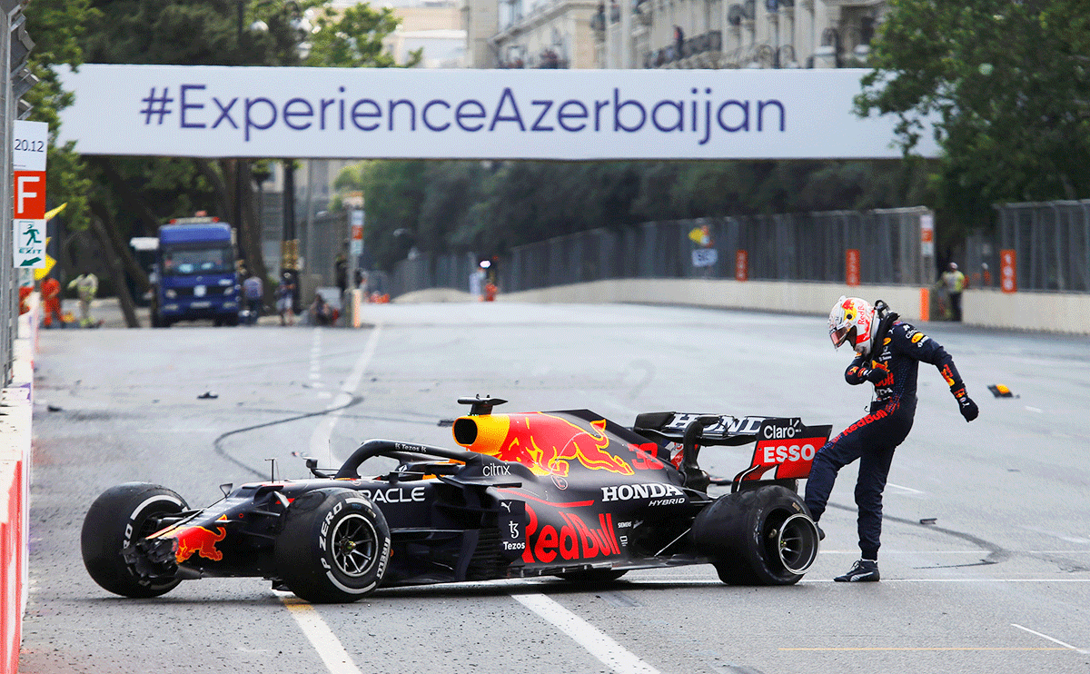 Red Bull's Max Verstappen kicks the wheel of his car after crashing out of the race 