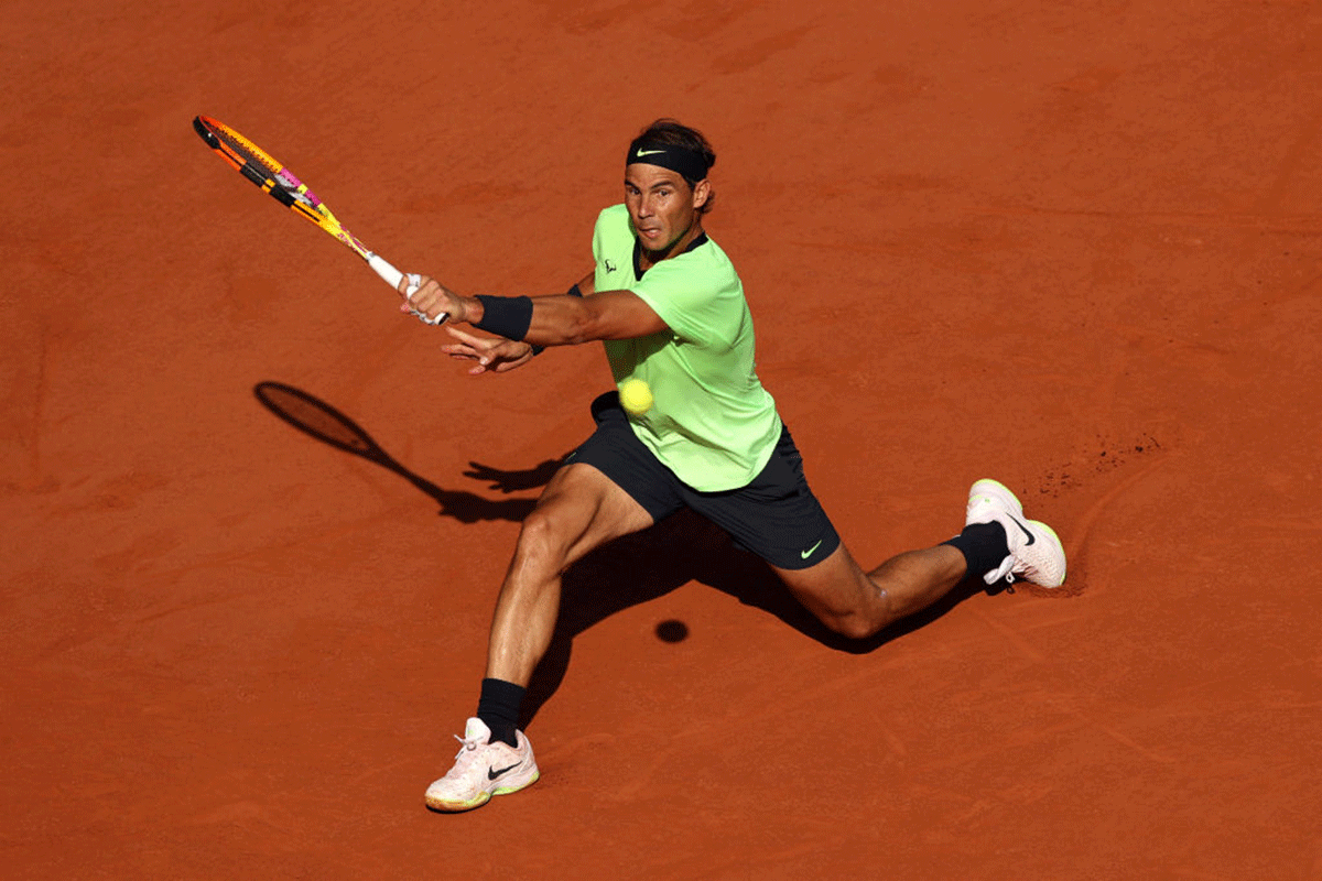 Rafael Nadal plays a backhand return against Jannik Sinner
