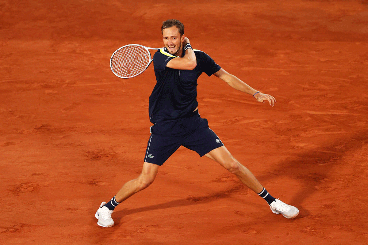 Daniil Medvedev returns against Stefanos Tsitsipas