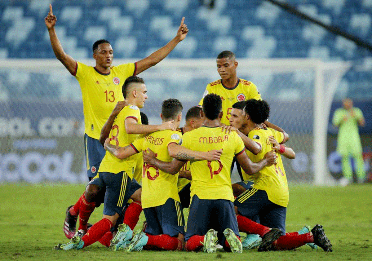Colombia's Edwin Cardona celebrates scoring their first goal with teammates during their Group A match against Columbia at Arena Pantanal, Cuiaba, Brazil on Sunday 