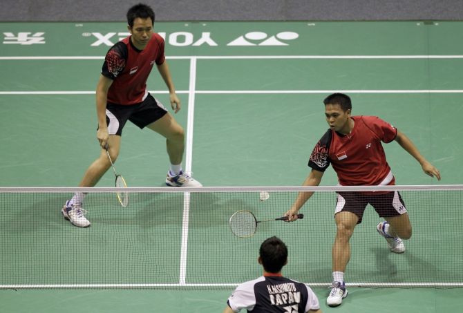 Indonesia's Markis Kido (right) returns a shot to Japan's Hirokatsu Hashimoto (centre) and Noriyasu Hirata (not pictured), as his partner Hendra Setiawan watches, during their men's doubles quarter-final of the Thomas Cup badminton championship in Wuhan, Hubei province, on May 23, 2012