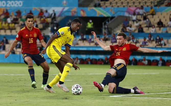 Sweden's Alexander Isak is challenged by Spain's Aymeric Laporte.