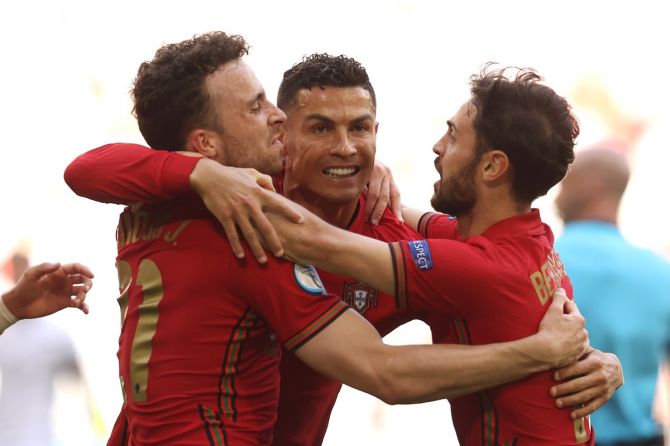 Cristiano Ronaldo celebrates with Diogo Jota and Bernardo Silva who together set up Portugal's goal. 