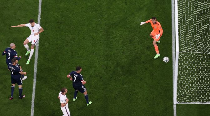 Scotland's David Marshall watches anxiously as a header from England's John Stones hits the post.