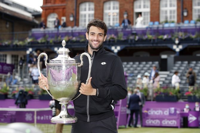 Italy's Matteo Berrettini poses with the trophy as he celebrates winning the Queen's Club final against Britain's Cameron Norrie on Sunday.