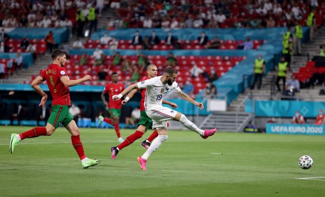 Karim Benzema runs past Portugal defenders to score France's second goal.