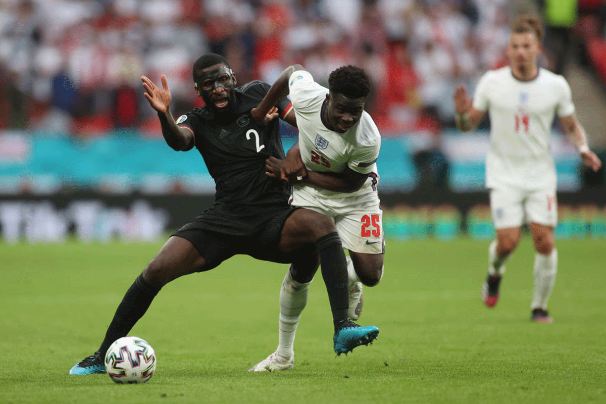 England's Bukayo Saka battles for possession with Germany's Antonio Ruediger 
