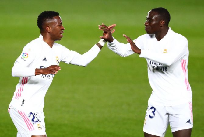 Real Madrid's Vinicius Junior celebrates with Ferland Mendy after scoring their first goal against Real Sociedad at Estadio Alfredo Di Stefano, Madrid, on Tuesday