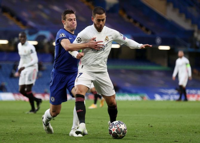Real Madrid's Eden Hazard battles for possession with Chelsea's Cesar Azpilicueta