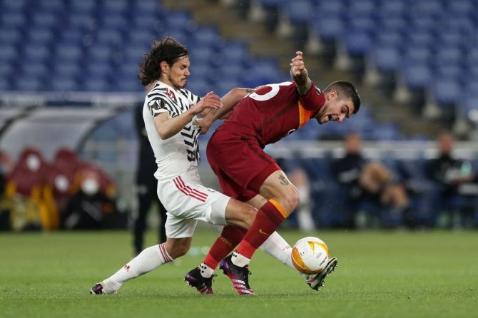 AS Roma's Gianluca Mancini is challenged by Manchester United's Edinson Cavani during their UEFA Europa League semi-final second leg match at Stadio Olimpico in Rome on Thursday