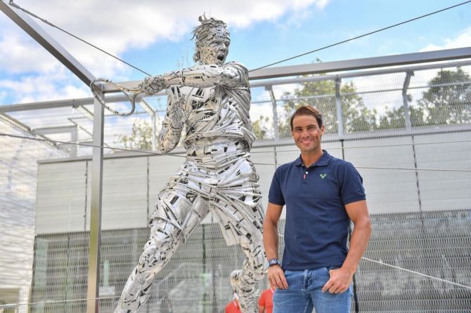Rafael Nadal poses alongside the statue of himself that was unveiled on Thursday