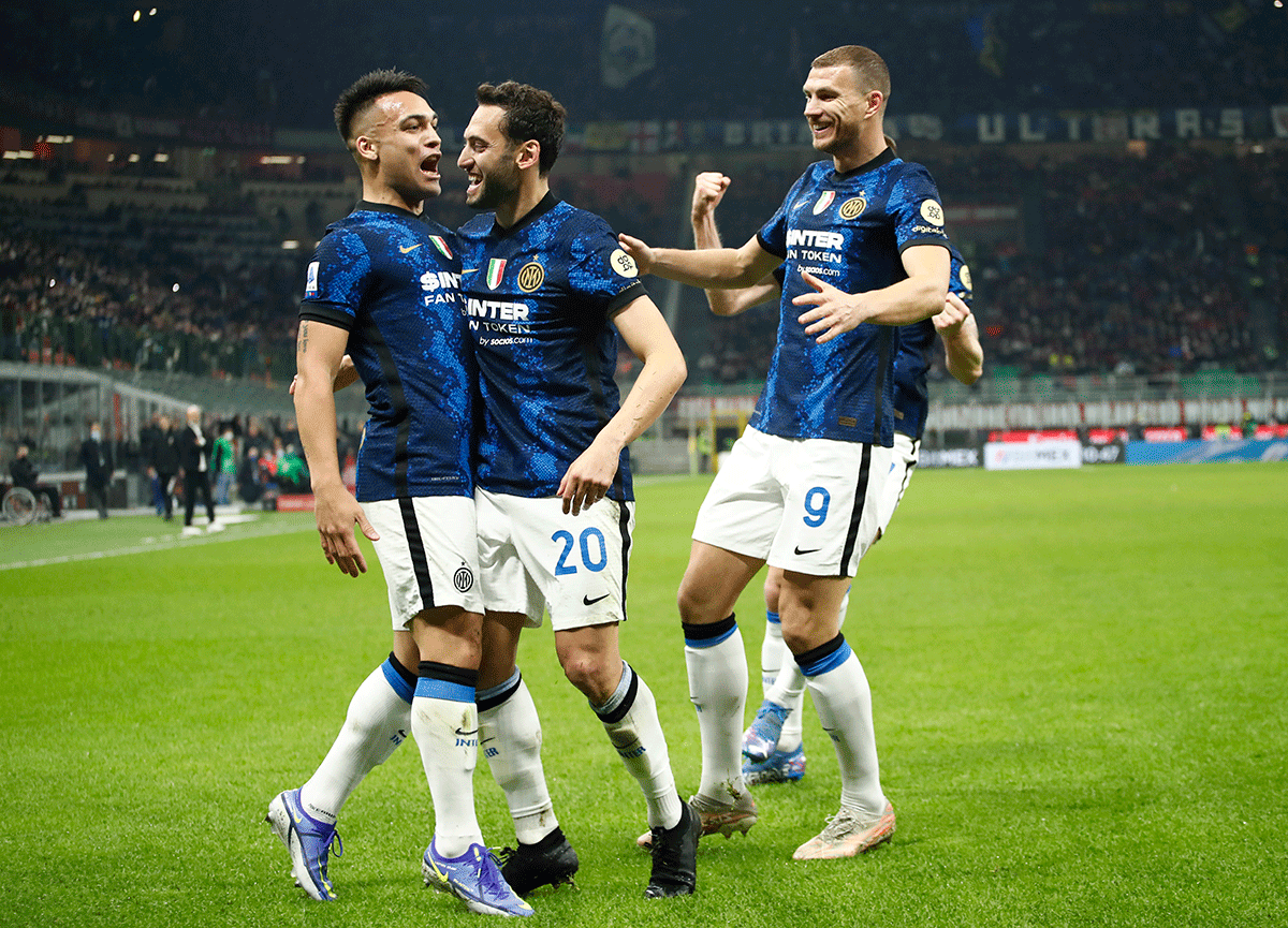Inter Milan's Hakan Calhanoglu celebrates scoring their first goal from the penalty spot with teammates during the Serie A match at San Siro, Milan