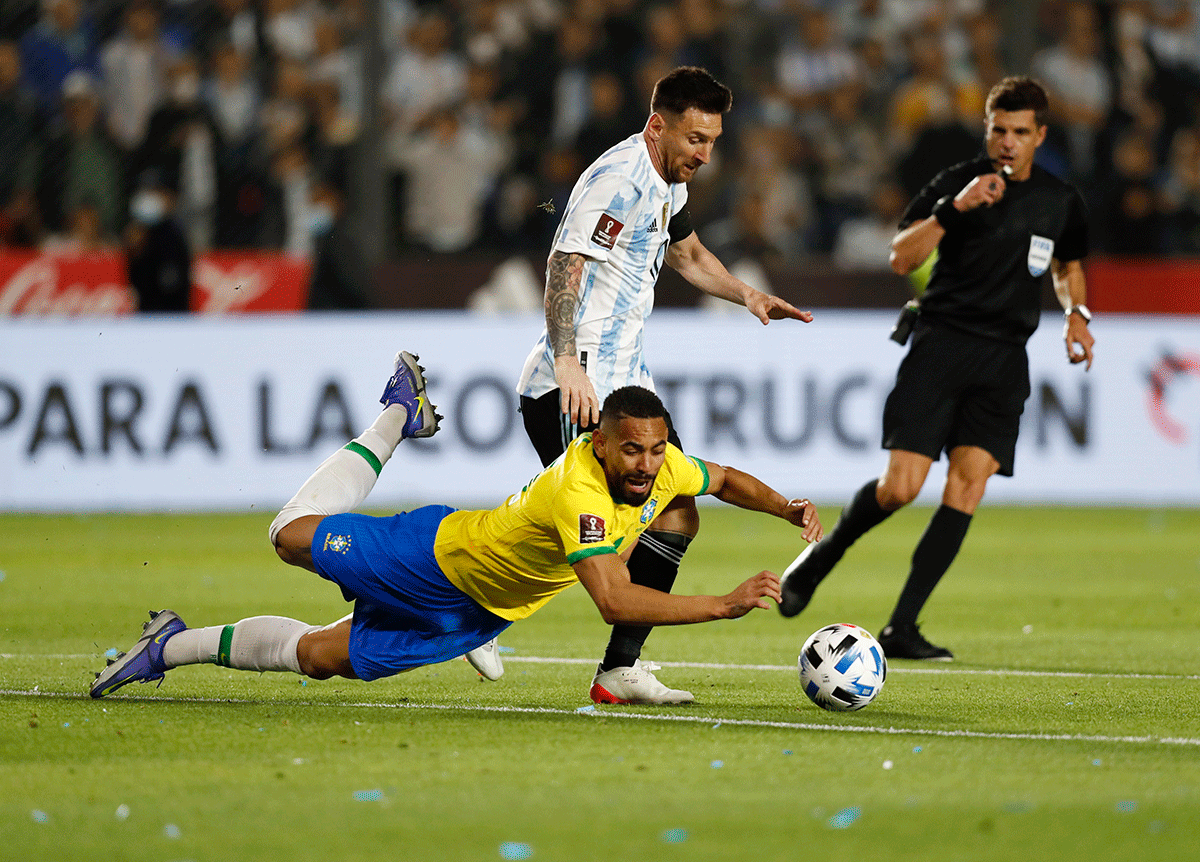 Argentina's Lionel Messi runs past Brazil's Matheus Cunha 