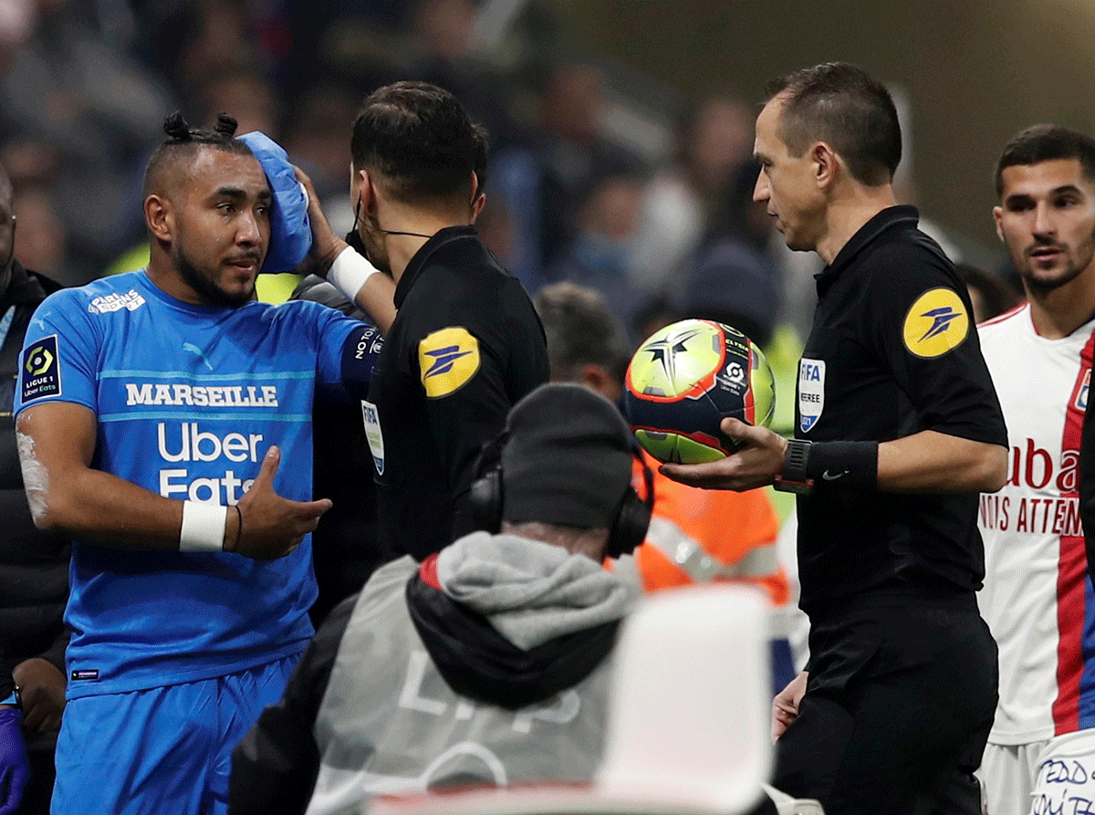 Olympique de Marseille's Dimitri Payet walks off the pitch injured after being hit by a water bottle thrown by a fan leading to the game against Olympique Lyon being interrupted at Groupama Stadium, Lyon, France