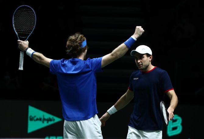 Aslan Karatsev and Andrey Rublev celebrate winning their doubles match against Spain's Marcel Granollers and Feliciano Lopez.