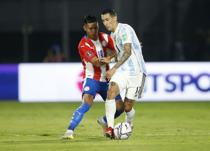 Argentina's Angel Di Maria battles for possession with Paraguay's Santiago Arzamendia during the South American World Cup qualifier in Asuncion, Paraguay.