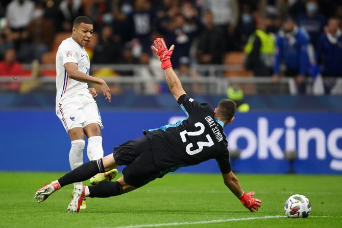 Kylian Mbappe sends the ball past Spain goalkeeper Unai Simon for France's second goal during the UEFA Nations League 2021 final, at San Siro Stadium in Milan, Italy, on Sunday.