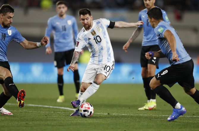Argentina's Lionel Messi breaks through a host of Uruguay defenders at El Monumental, in Buenos Aires, Argentina.
