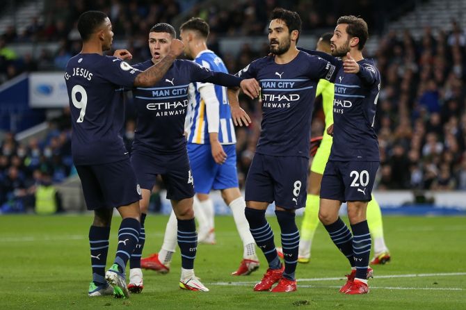 Ilkay Guendogan celebrates with teammates Gabriel Jesus, Phil Foden and Bernardo Silva after scoring Manchester City's opening goal during the Premier League match against Brighton & Hove Albion, at American Express Community Stadium in Brighton. 