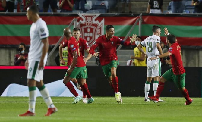 Cristiano Ronaldo celebrates with his teammates after scoring Portugal's first goal. 