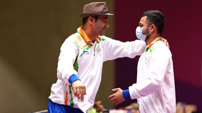 India's Manish Narwal celebrates with compatriot Singhraj Adana after winning the gold medal in P4 Mixed 50m Pistol SH1 event at the Paralympics, in Tokyo, on Saturday. 