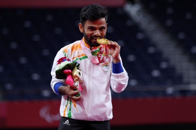 India's Krishna Nagar celebrates on the podium with his gold medal from the men's singles SH6 badminton. 