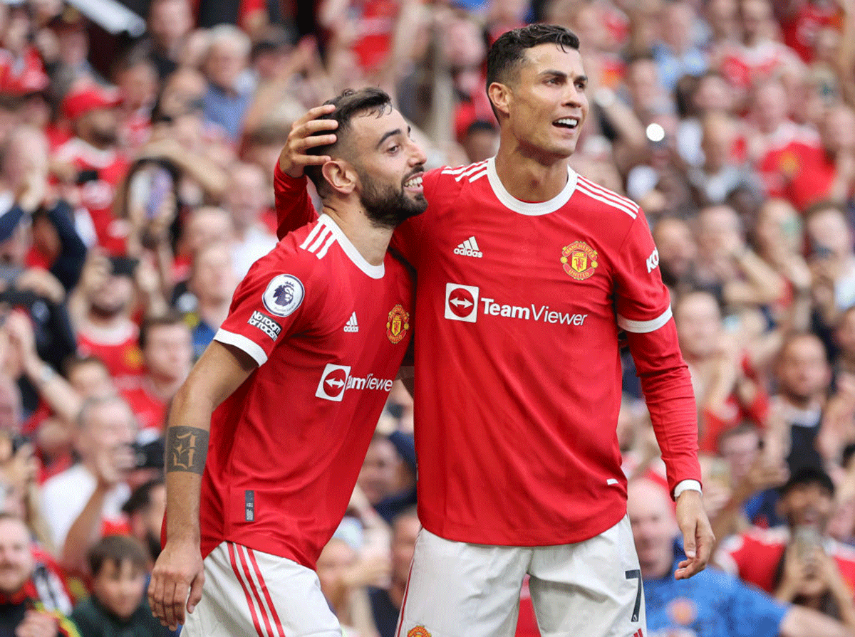 Bruno Fernandes celebrates with Cristiano Ronaldo after scoring