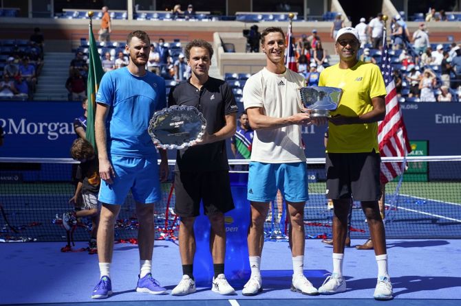 (From left) Runners-up Jamie Murray of Great Britain and Bruno Soares of Brazil, and champions Joe Salisbury of Great Britain and Rajeev Ram of the United States pose with their US Open men's doubles trophies.