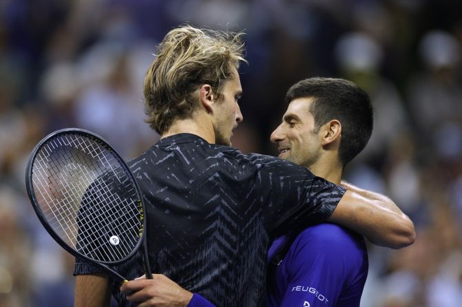 Alexander Zverev, left, and Novak Djokovic share a warm embrace and some words at the net after their men's singles semi-final.