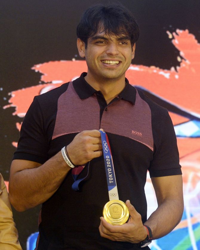 Tokyo 2020 Olympics gold medalist Neeraj Chopra shows his medal during a chat show in Kolkata on Wednesday.