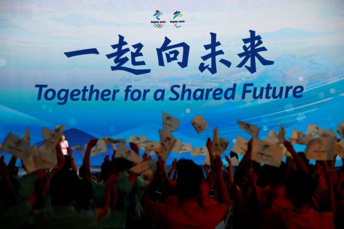 The slogan for the Beijing 2022 Winter Olympics, 'Together for a shared future, is unveiled on a giant screen at a ceremony in Beijing, China, on Friday, September 17, 2021.