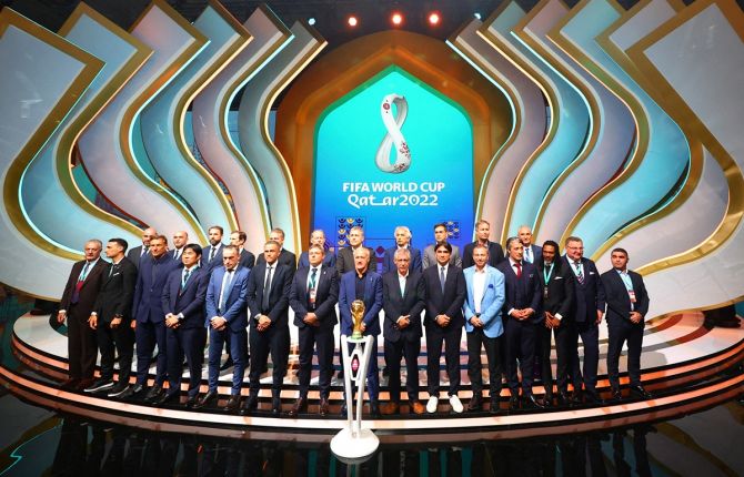 Coaches of the 2022 World Cup finals teams pose for a photograph after the draw, at the Doha Exhibition and Convention Center, in Qatar, on Friday.