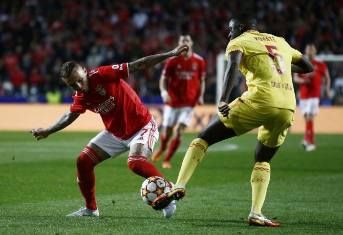 Benfica's Everton and Liverpool's Ibrahima Konate battle for possession. 